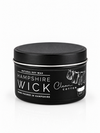 A black metal tin of Hampshire Wick natural soy wax candle, featuring a black lid and a label with white text and illustrations, set against a clean white background.