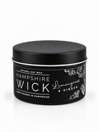 A black tin of Hampshire Wick Lemongrass & Ginger natural soy wax, shown on a clean white background with a subtle reflection.