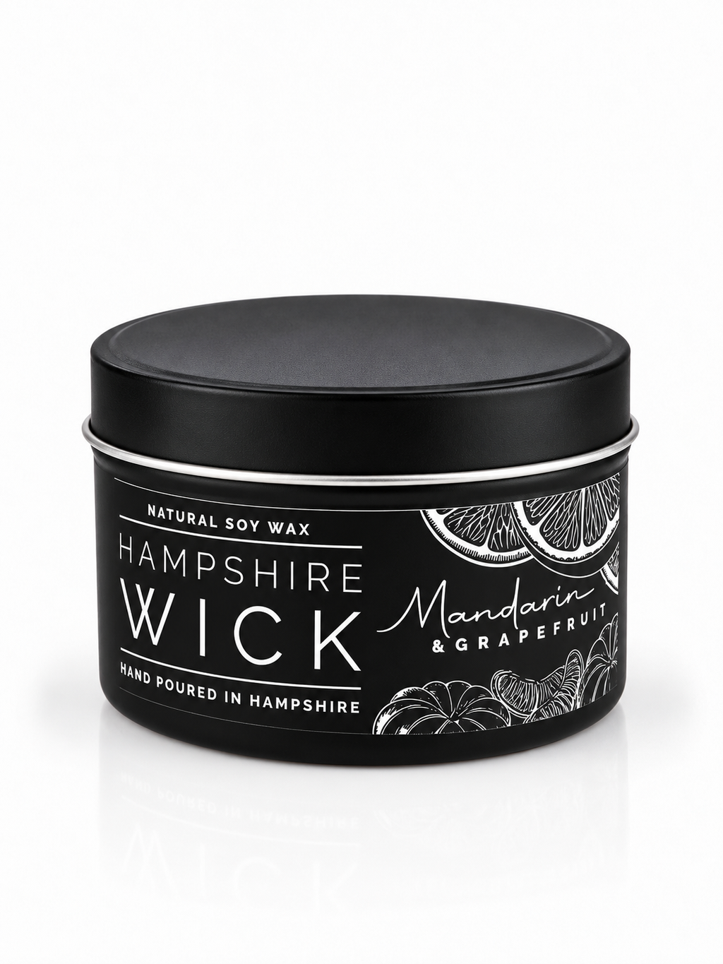 A black tin of Hampshire Wick natural soy wax candle in the Mandarin & Grapefruit scent, shown on a clean white background with a subtle reflection.