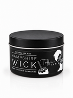 A black tin of Hampshire Wick natural soy wax in Toffee Apple scent, featuring white text and illustrations of an apple and a hand holding a stick, on a white background.