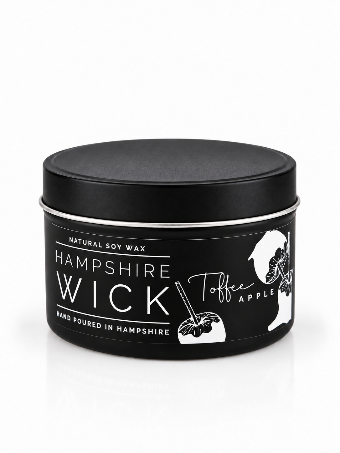 A black tin of Hampshire Wick natural soy wax in Toffee Apple scent, featuring white text and illustrations of an apple and a hand holding a stick, on a white background.